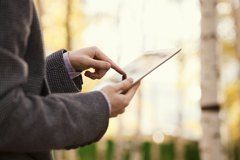 Person using a tablet to access online data